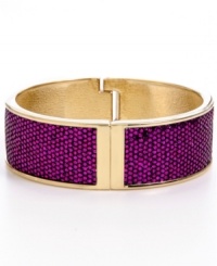 Your inner girly girl will be drawn to the glam qualities of Betsey Johnson's glitter bangle. Crafted in gold-plated mixed metal, bangle features a secure hinge closure and fuchsia glitter overlay. Approximate diameter: 2-1/2 inches. Approximate length: 8 inches.