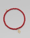 The hamsa, a traditional protective amulet, is encrusted with diamonds and accented with one ruby as it hangs from a stretchy strand of richly colored coral beads. Diamonds, 0.05 tcw Coral 14k yellow gold Diameter, about 2 (unstretched) Charm length, about ½ Imported