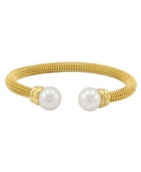 Lovely and lustrous. Organic man-made pearls adorn this beautiful bangle bracelet from Majorica. Crafted in gold tone stainless steel, it's a chic complement for your workday wardrobe. Approximate diameter: 2-1/2 inches.