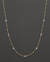 A yellow and white gold necklace with bezel-set diamond stations. With signature ruby accent. Designed by Roberto Coin.