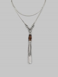 A bamboo bead and sterling silver tassels drop elegantly from a modern, snake-inspired chain with horsebit details. Bamboo Sterling silver Length around neck, about 43 Made in Italy