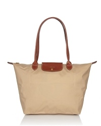 Longchamp's signature nylon tote in a large size lends sophisticated chic to every look, from city jaunts to weekend getaways. Folds up for ease during travel.