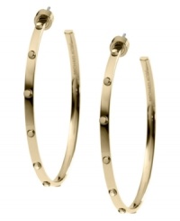 Bring some edge to a timeless look. Michael Kors added stud detail to a classic metal hoop earring. Crafted in gold tone mixed metal. Approximate diameter: 2 inches.