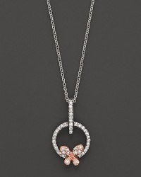 A dainty diamond butterfly pendant set in 14K. rose and white gold.