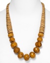 Tribal-inspired chic from RJ Graziano. This bold necklace marries graduated tan stone discs with multifaceted tiger's eye beads for a versatile piece that works well a black dress or dark jeans.