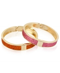 Sleek and stylish. This pair of bangle bracelets from Betsey Johnson is crafted from gold-tone mixed metal with pink and orange glitter lending them a vibrant touch. Approximate diameter: 2-1/4 inches.