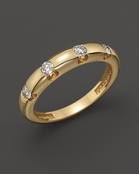 Diamonds dot a 14K yellow gold band.