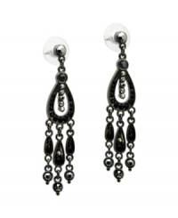 Take it to the edge in daring drops with bold color. GUESS chandelier earrings feature glittering black crystals set in hematite tone mixed metal. Approximate drop: 1-1/2 inches.