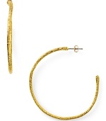 Designer Alexis Bittar plays rough with these textured gold plated hoop earrings, boasting a simple shape and faceted finish.