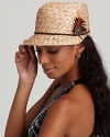 A beautiful woven hat with a thin braided belt and feather accents at side.