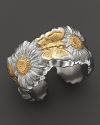 A butterfly and daisy design is detailed in 18K yellow gold accents on Buccellati's band ring.