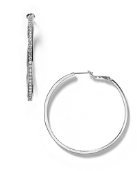 Glamorous inside-out hoops rendered in a small size are accented with fine cubic zirconia for subtle sparkle.