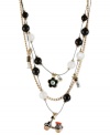 Go along for the ride. This illusion necklace from Betsey Johnson is crafted from gold-tone mixed metal with a scooter-styled charm at the center, and crystal accents and black and white beads adding a stylish touch. Approximate length: 16 inches + 3-inch extender. Approximate drop: 3-1/2 inches.