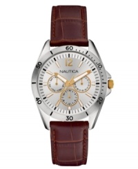 Flashes of golden tones update this brown leather watch from Nautica.