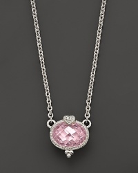 A romantic heart tops this faceted, oval-cut pendant.