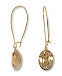 Gold rush. Inspired by young Hollywood, a trendy golden shadow crystal adds a dramatic design detail to Swarovski's linear drop earrings. The gold tone mixed metal setting complements the golden hue of the crystal. Approximate drop: 1-3/4 inches.