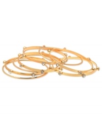 GUESS goes for a minimalist approach with this set of 9 bangle bracelets. Crafted from gold-tone mixed metal, the bangles feature glass stone accents for a stylish complement. Approximate diameter: 2-1/2 inches.