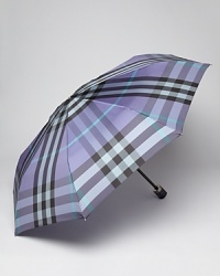 Easily stowed, this classic check umbrella from Burberry boasts endless style in a compact size.