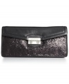 After-hours attire deserves exquisite style, like this party-perfect clutch form Cole Haan. Crafted in ultra-soft leather with sparkly sequin detailing, the surprisingly spacious interior holds cards, cash, phone and other mini must-haves.