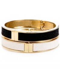 A totally dynamic duo. Betsey Johnson's two bangle set makes quite the statement in chic, contrasting colors. Crafted in gold-plated mixed metal with a glitter overlay and secure hinge clasp. Approximate length: 8 inches. Approximate diameter: 2-1/2 inches.