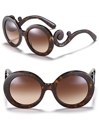 Thick round frames and curling temples make for statement-making sunglasses from Prada.