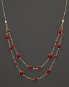 Two rows of bright red enamel stations and diamond accents highlight this collar necklace from Roberto Coin.