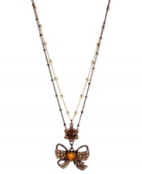 Lovingly wrapped in gold and brown hues, this two-row necklace from Betsey Johnson showcases a bow with topaz pave accents and a crystal heart accent. Crafted in brown tone mixed metal. Approximate length: 16 inches + 3-inch extender. Approximate drop: 2-1/4 inches.