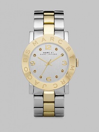 A sleek timepiece with a logo etched bezel and dazzling crystal markers. Quartz movementWater resistant to 5 ATMRound stainless steel case, 36mm (1.4) Logo etched goldtone ion-plated bezelSilver dialCrystal and numeric hour markersSecond hand Two-tone stainless steel link braceletImported 