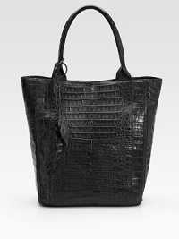 Luxurious croc-skin crafted in a roomy carryall and finished with leaf cut-out tassels.Double top handles, 8 drop Magnetic closure One inside zip pocket One cell phone pocket Suede lining 12W X 14½H X 5½D Imported