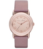 Tastefully trendy. The perfect amount of pink shimmer warms up this watch by Marc by Marc Jacobs. Metallic blush leather strap and round rose-gold ion-plated stainless steel case. Rose-gold tone mirrored dial features rose-gold tone logo letters at markers and three hands. Quartz movement. Water resistant to 50 meters. Two-year limited warranty.