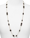 A smattering of shapely jet black bars dress up a simple chain on this long kate spade new york necklace, plated in gold.