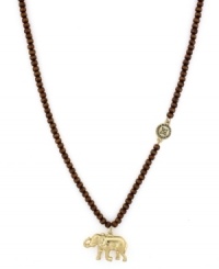 An elephant always brings good luck. BCBGeneration's Eastern-inspired pendant features a gold tone mixed metal charm and charm accents strung from a wood bead chain. Approximate length: 24 inches. Approximate drop: 1 inch.