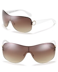 Keep your cool in MARC BY MARC JACOBS rimless shield wrap sunglasses with contrast arms and large logo detail at temples.