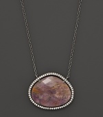 Diamonds circle a faceted rutilated quartz and purple charoite doublet set in blackened sterling silver. By Di Massima.