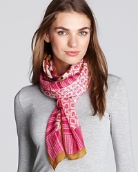 A lush floral print framed by geometric patterns and stripes adorns this chic silk-and-wool scarf from Tory Burch.