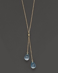 Twin blue topaz briolettes sparkle from this 14K yellow gold lariat necklace.