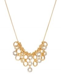 A shimmering mixture of golden rings lend an elegant look to this frontal necklace by Kenneth Cole New York. Crafted of gold tone mixed metal embellished with crystal accents. Approximate length: 16 inches + 3-inch extender. Approximate drop: 1-1/4 inches.