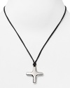 A plated silver cross pendant is a Gothic focal point on this Robert Lee Morris Soho necklace comprised of matte black cord.