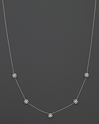 Five faceted diamond stations bloom on an 18K white gold necklace. By Roberto Coin.