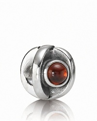 A sterling silver eye charm with garnet iris adds a blink of color to your PANDORA bracelet.