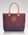 Take this season's color block trend with you anywhere and fill it with everything. This dipped canvas tote from Tory Burch flaunts practical style, sturdy trims, and a must-have mixed media finish.