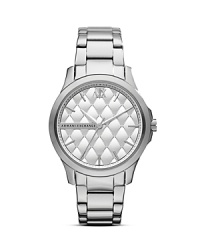 A quilted matte dial tops this sleek and round Armani Exchange watch, adding textured interest to a timeless plated stainless steel bracelet.