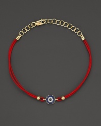 Diamonds and blue sapphires in 14K. yellow gold from a dazzling evil eye charm, strung on red rope. By Meira T.