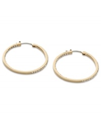 These timeless hoop earrings from Fossil get a glitzy upgrade with black diamond crystal accents. Crafted in shiny gold tone mixed metal. Approximate diameter: 1-3/8 inches.