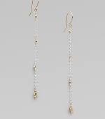 Gracefully dangling strands of sterling silver chain, sprinkled and tipped with glowing faceted beads of 14k gold.14k yellow gold and sterling silverLength, about 2¼Ear wireMade in USA