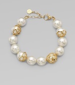 An exquisite strand of pearls accented with 18k gold flower cup caps.14mm round white organic man-made pearls18k goldplated sterling silverLength, about 7½ Lobster clasp closureImported 