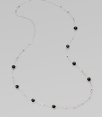 A long sterling silver chain with hammered bead and faceted onyx stations.Onyx Sterling silver Length, about 38 Lobster clasp closure Imported 