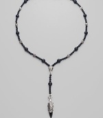 A strand of large and small black onyx beads, interspersed with textured sterling silver beads, with a Y-shaped drop, capped by a dramatic carved raven's head. Black onyx Sterling silver Length, about 15 Drop, about 4 Lobster clasp Imported