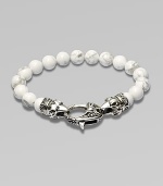 A new look for the modern man, handsomely crafted with a sterling silver raven's head clasp and a string of howlite beads.Sterling silverLobster claspBracelet, 9 longAbout 3 diamImported