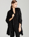 Sparkle, shine and shimmer with your every step, as this DKNY shawl lights up your look with a stunning sequin finish.